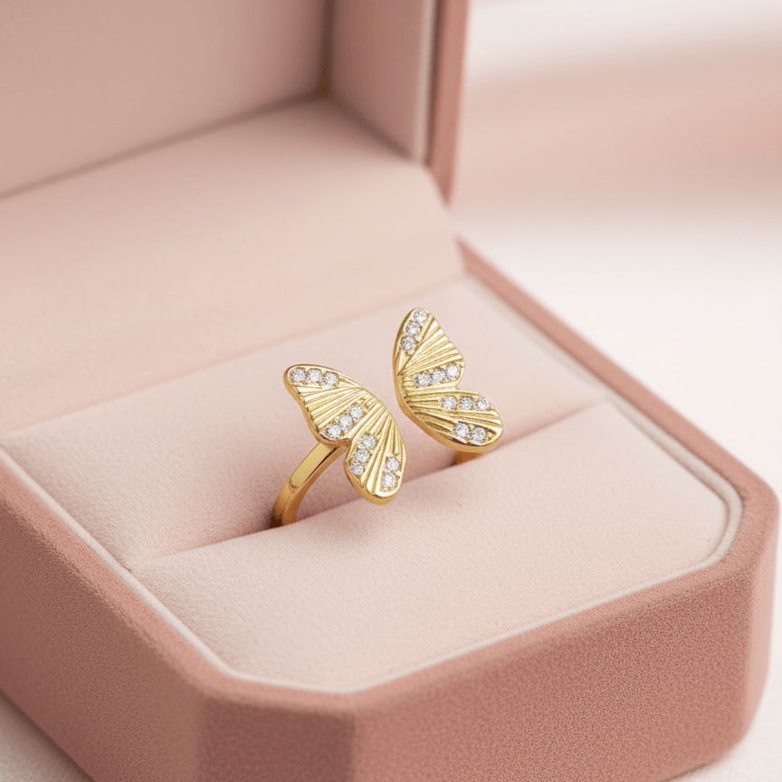 Gold butterfly ring in a pink jewelry box