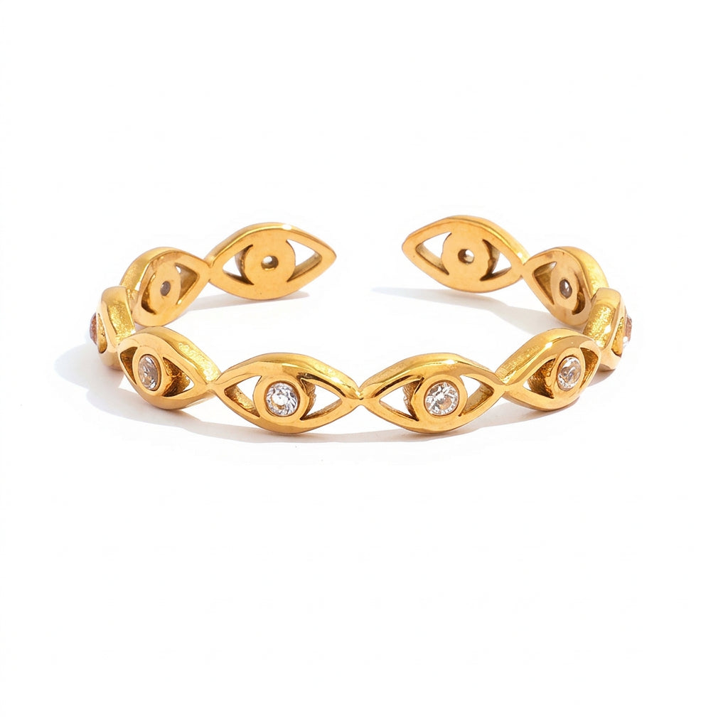 Gold adjustable cuff bracelet with an eye motif and clear rhinestones, shown with measurement callouts and weight text on a white background.