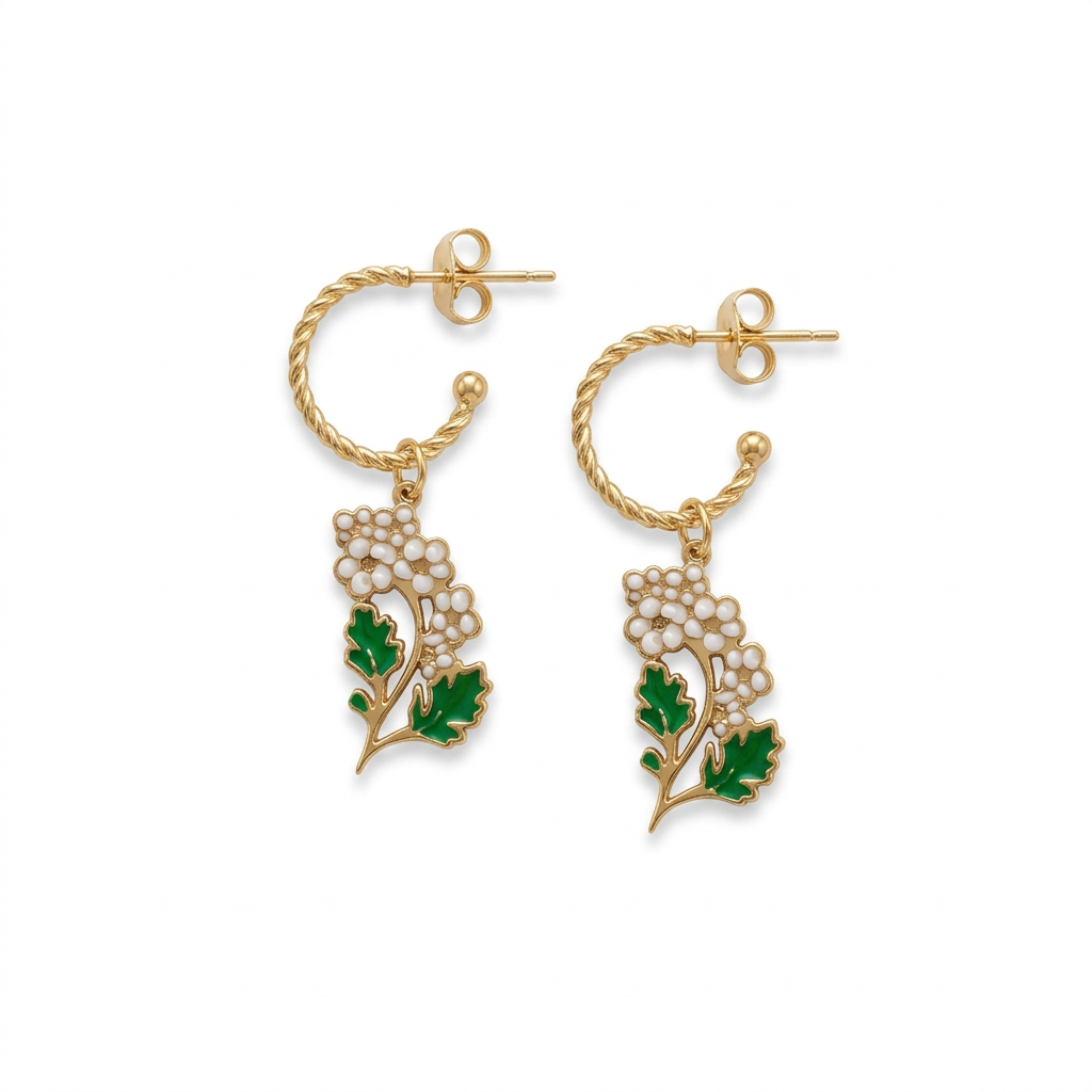 Gold twisted hoop earrings with white floral charms and green leaves on a white background
