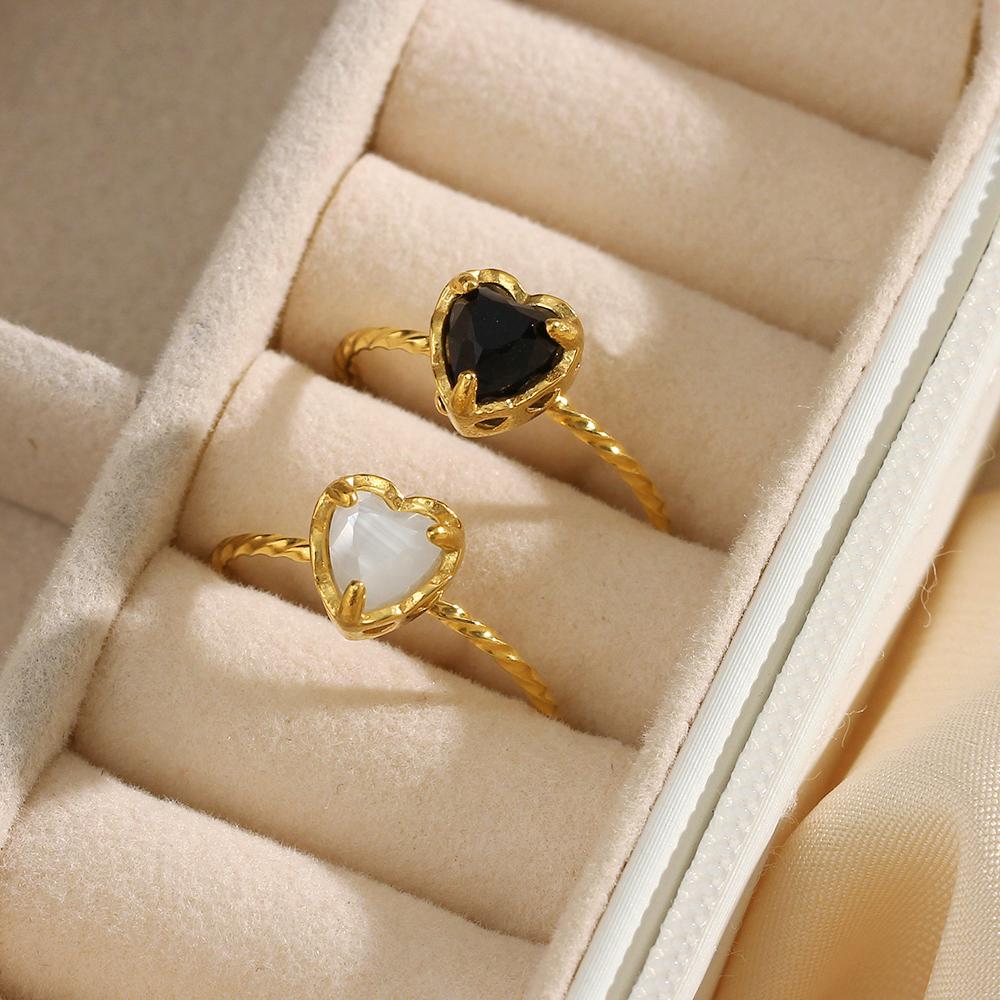 black and white stone on a gold ring - CinloCo